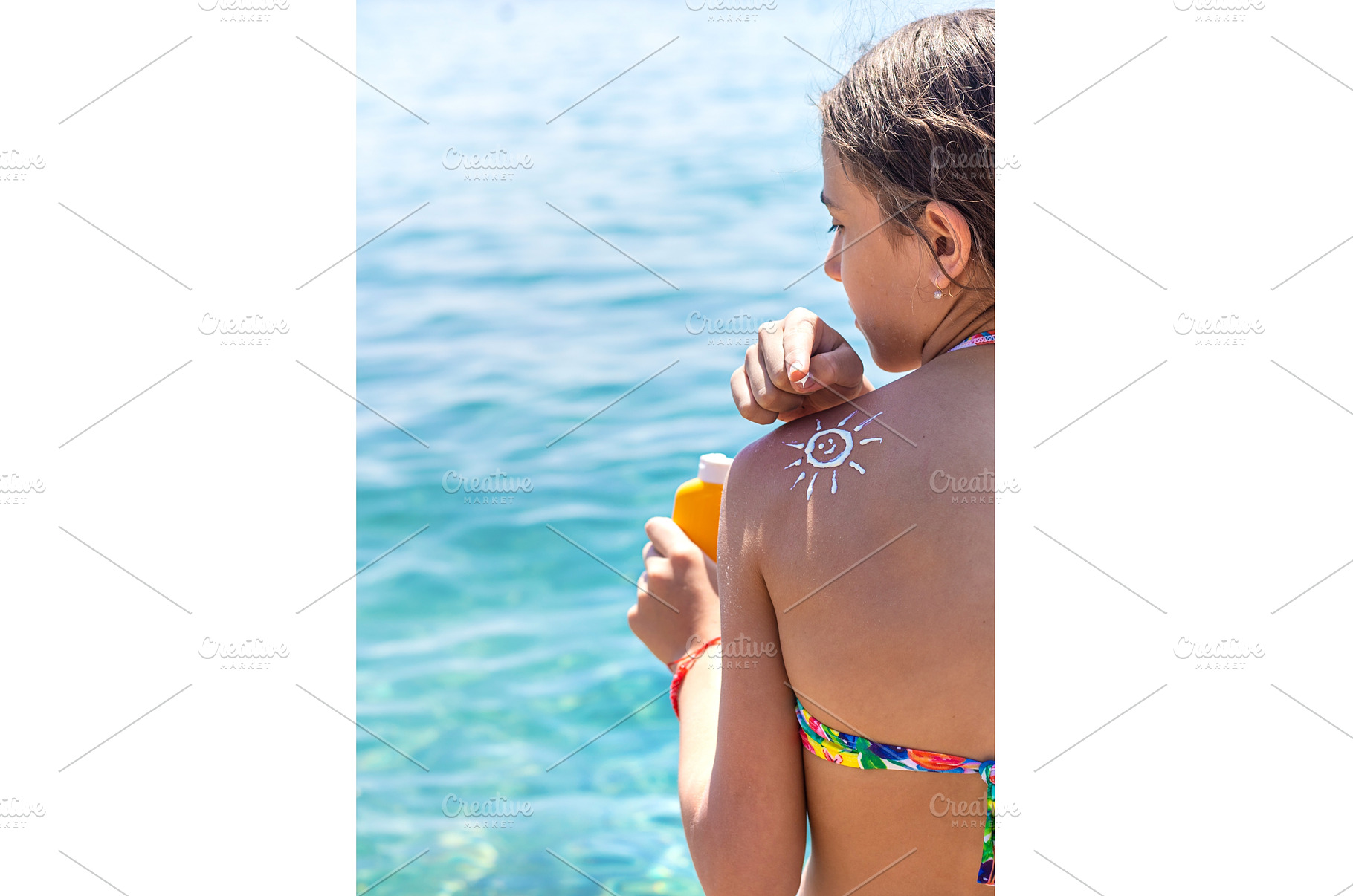 The child has sunscreen on his back, a Holiday Photo by yanadjana