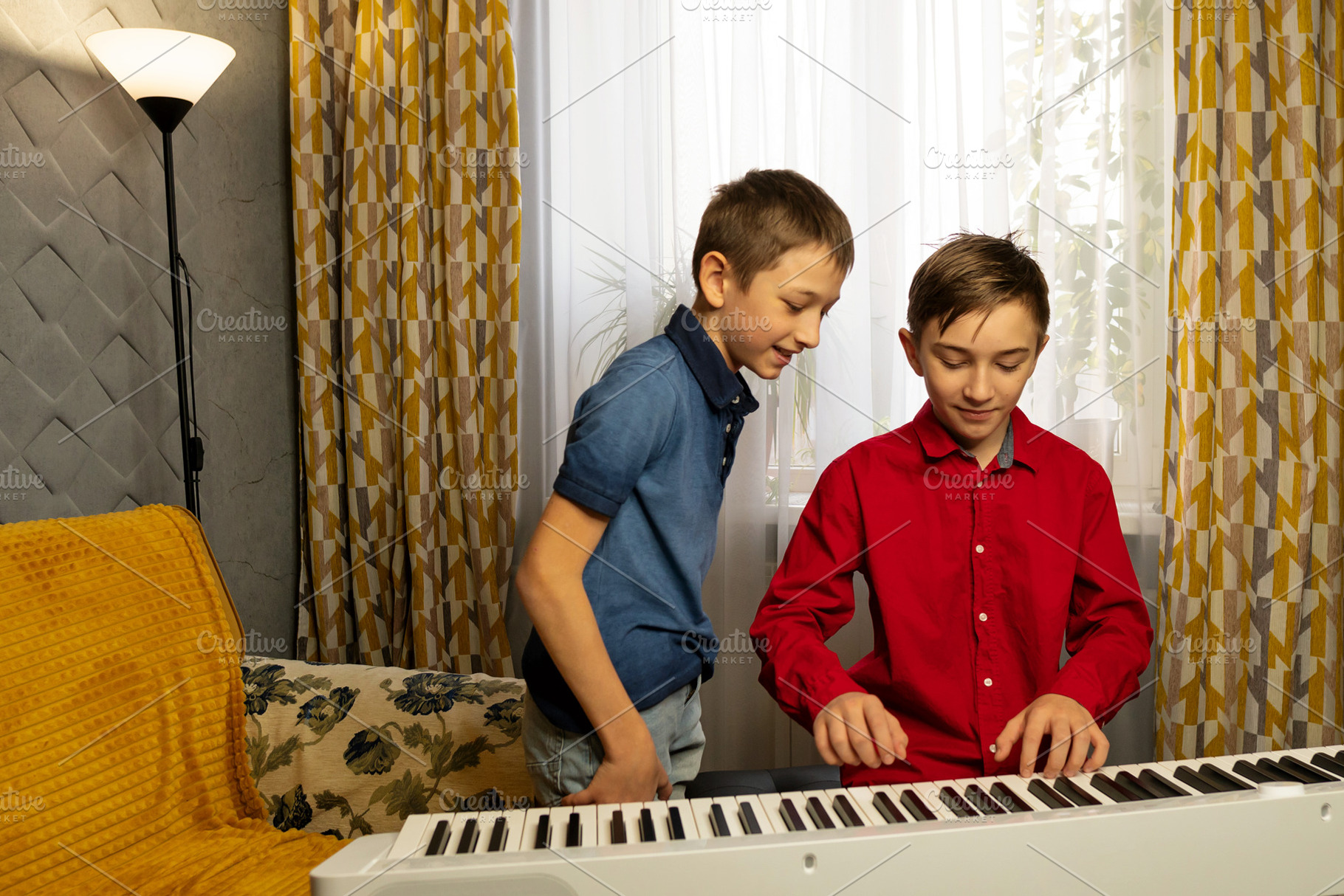 Two boys playing the piano together, a School & Education Photo by Elena Vagengeim