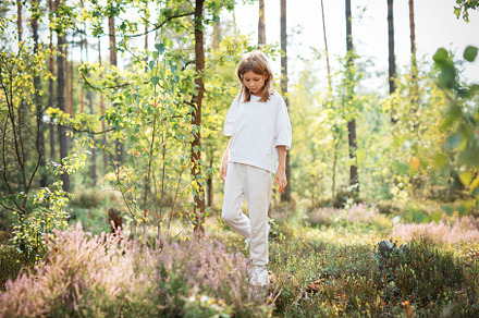 A young girl explores a serene forest in bright daylight, surrou, a Person Photo by Olena Rudo