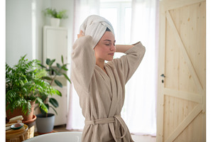young woman enjoying hair care, a Person Photo by HalfPoint