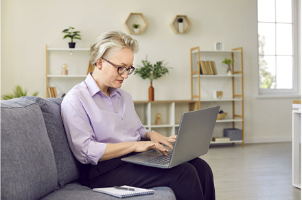Senior stylish woman sitting on sofa, a Business Photo by StudioRomantic