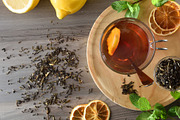 Black tea with lemon and mint on wooden table top, a Food & Drink Photo by Davizro's Market (Thumbnail 1 of 2)