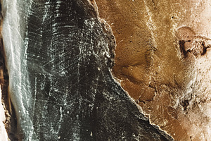 black color gradually turns into gold. stone texture. patterns and wallpaper