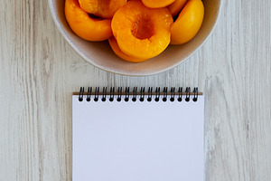 Healthy Organic Canned Peach Halves in a Bowl, blank notepad, to, a Food & Drink Photo by LiudmylaChuhunova