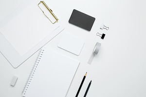 Monochrome stationery items. On a white background, an empty mock up notebook a, a Photo by matucha