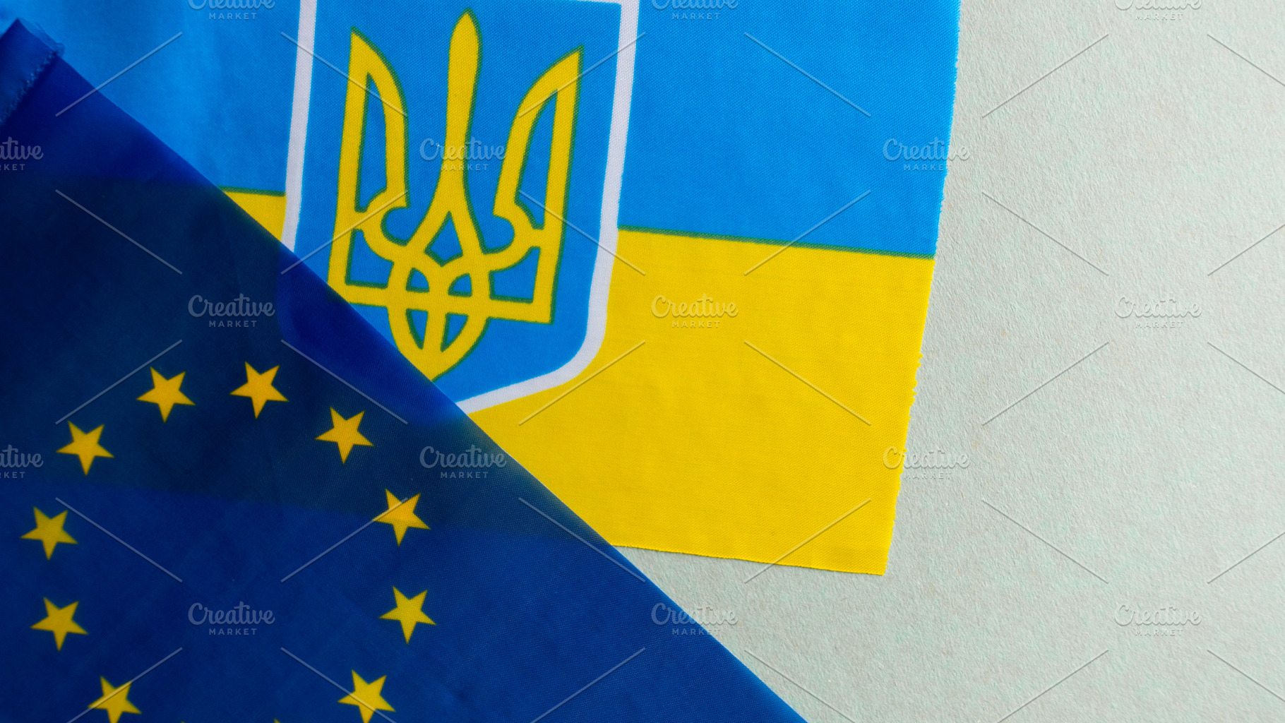 European union and Ukraine two folded silk flags together, a Background Photo by OleksandrRybitskyi