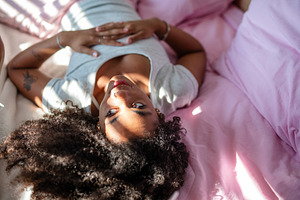 Pensive young woman lying in bed in, a Person Photo by HalfPoint
