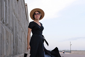 Confident woman in black dress stand, a Person Photo by Elena Vagengeim