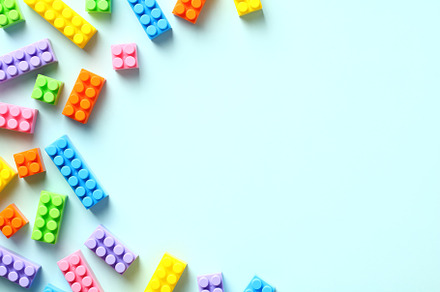 Colorful toy building blocks on pastel blue background. Baby educational game., a School & Education Photo by photoguns