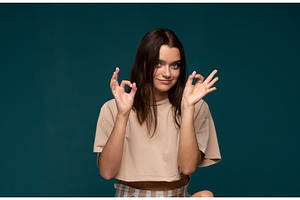 Happy woman making an ok sign with, a Person Photo by volodymyrshtun13795