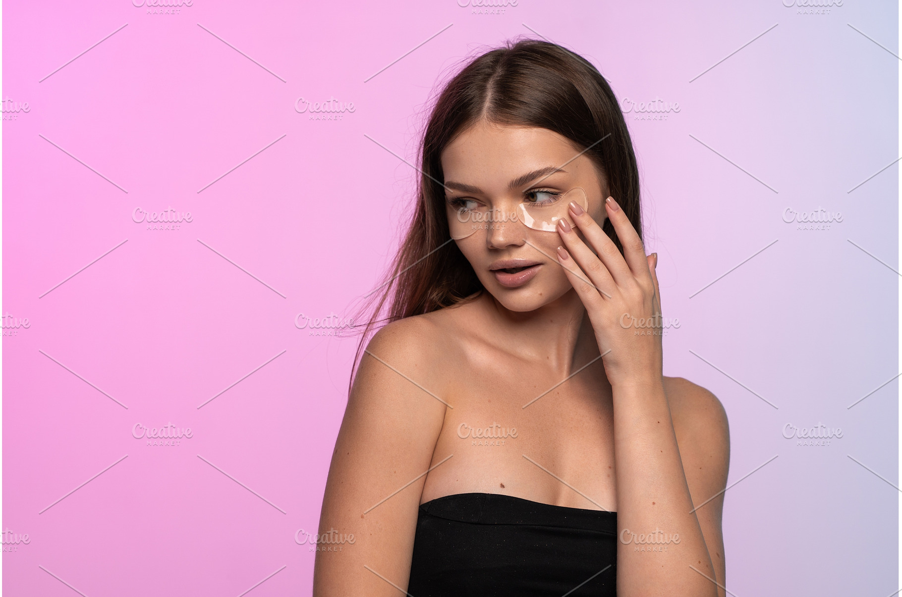Young woman applying under eye, a Beauty & Fashion Photo by volodymyrshtun13795