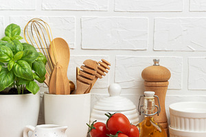 Kitchen utensils, fresh tomatoes, basil and olive oil creating a, a Food & Drink Photo by Olena Rudo