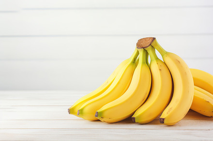 Ripe bananas on white wooden background, a Food & Drink Photo by AlyaAnd