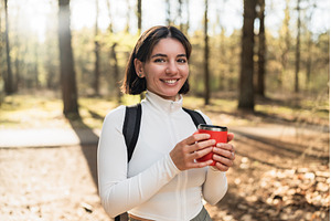 Hiker woman pausing in a forest to, a Nature Photo by AD Stock Images