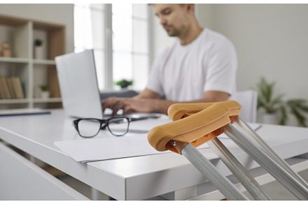 Close up of crutches on background, a Business Photo by StudioRomantic