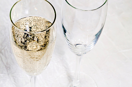 Champagne poured into two glasses close up, a Food & Drink Photo by TanaCh