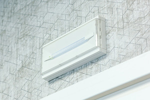 Emergency light on the wall providing safety and guidance during power outages, an Architecture Photo by Antonio Gravante Market