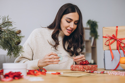 Woman wrapping Christmas Presents Gifts