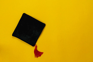 Top view graduation background containing equipment, document, and back to
