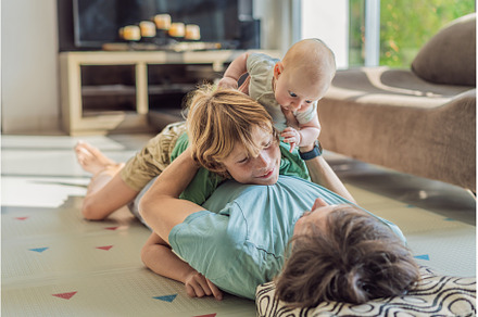 Father, son, and newborn baby lying, a Person Photo by Elizaveta Galitskaya