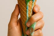 Earth shaped ice cream cone melting in human hand, a Person Photo by GoodGoods (Thumbnail 1 of 2)