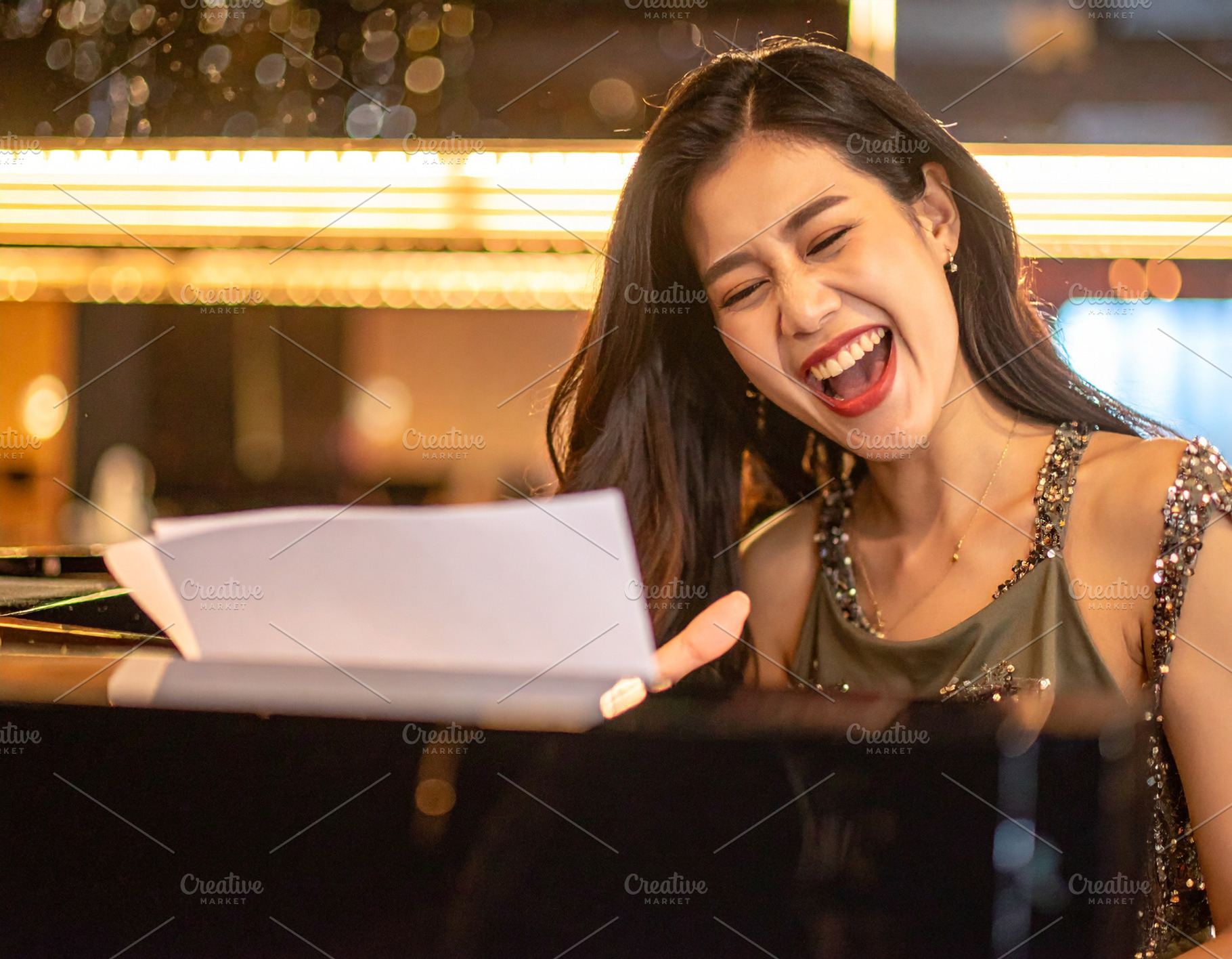 A beautiful singer playing piano at bar, a Person Photo by DanFLCreativo