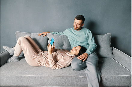 Smiling young couple embracing while, a Person Photo by Gladkov photography