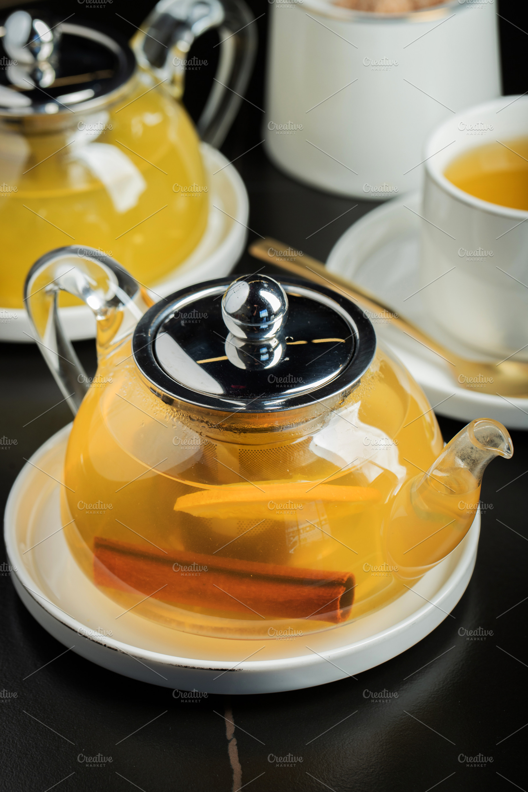 Fruit tea with mango and mint in a glass teapot on the table, a Food & Drink Photo by Budarinphoto