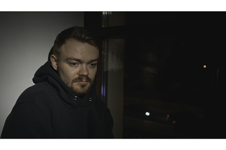 Sad man at night window of house, a Person Photo by Media Whale Stock