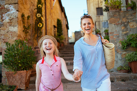 smiling stylish mom and child travellers exploring attractions, a Person Photo by Alliance Images