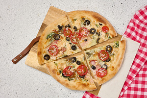 Appetizing pizza cut into pieces on a round white plate with tom, a Food & Drink Photo by ndanko