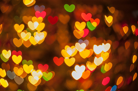 Heart background containing backlights, heart, and bokeh