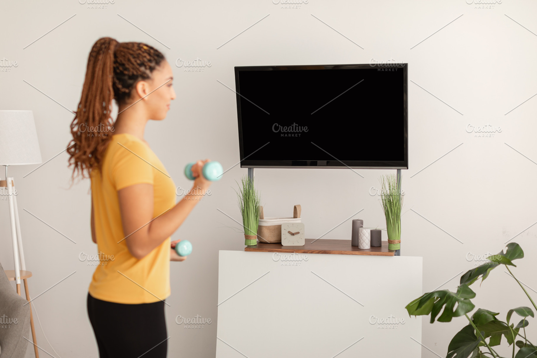 Sporty Black Female Exercising With Dumbbells At Home, Side View, a Photo by Prostock-Studio