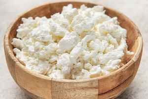 Cottage cheese in wooden bowl for healthy breakfast, a Food & Drink Photo by Olena Rudo