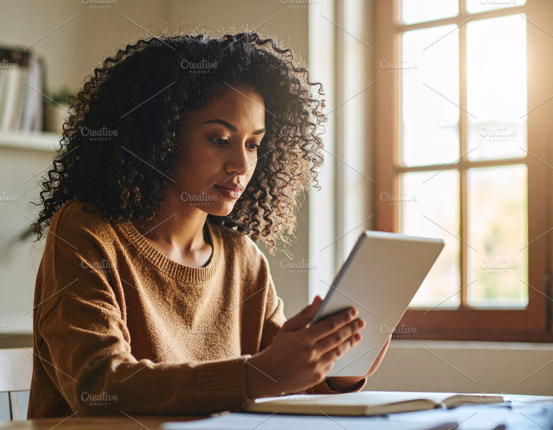 Young adult using a digital tablet to study at home, a School & Education Photo by DanFLCreativo