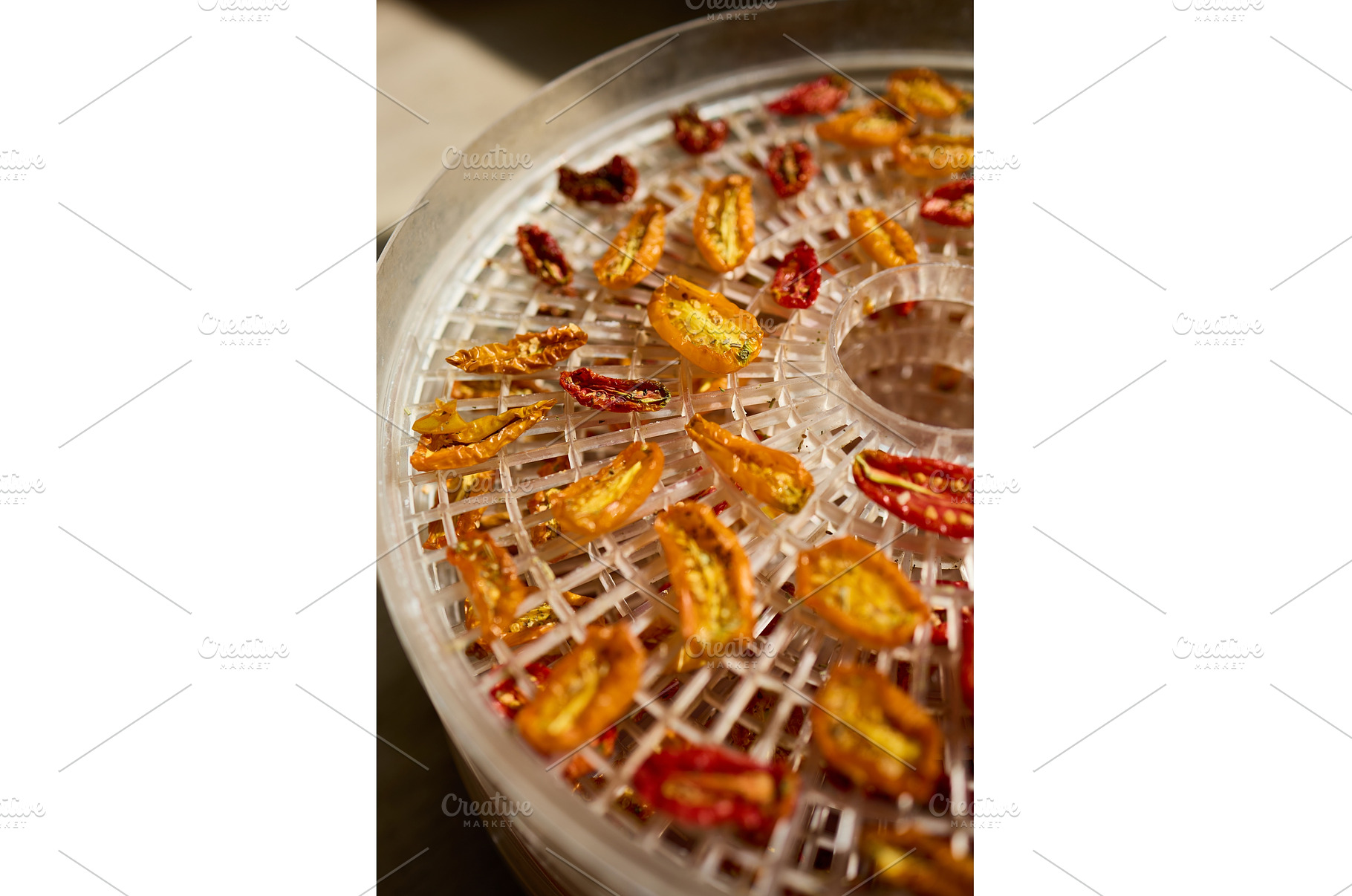 Drying colorful cherry tomatoes in a, a Food & Drink Photo by IlliaBondarPhotography
