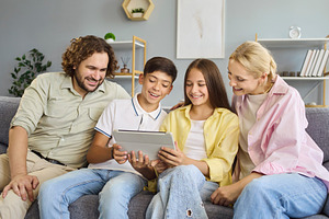 Family with Teens Sharing Tablet