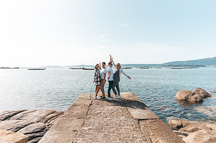 A pregnant couple and a young one near the ocean, a Person Photo by rubenchase
