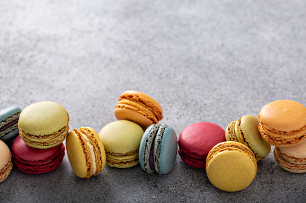Variety of colorful macarons on the table, a Food & Drink Photo by farwasser