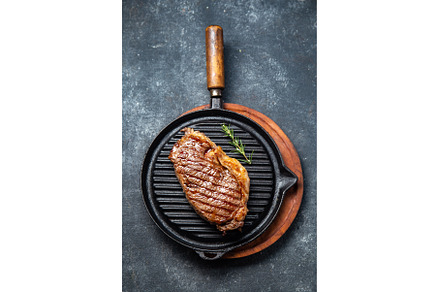 Fried strip loin steak on vintage, a Food & Drink Photo by LARISA BLINOVA