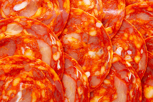 Cold Meat Chorizo Slices on a Wooden Board, top view. Close-up., a Food & Drink Photo by LiudmylaChuhunova