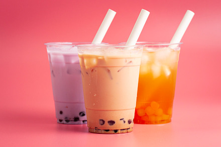 Three Different Types of Boba Tea on a Bright Pink Background
