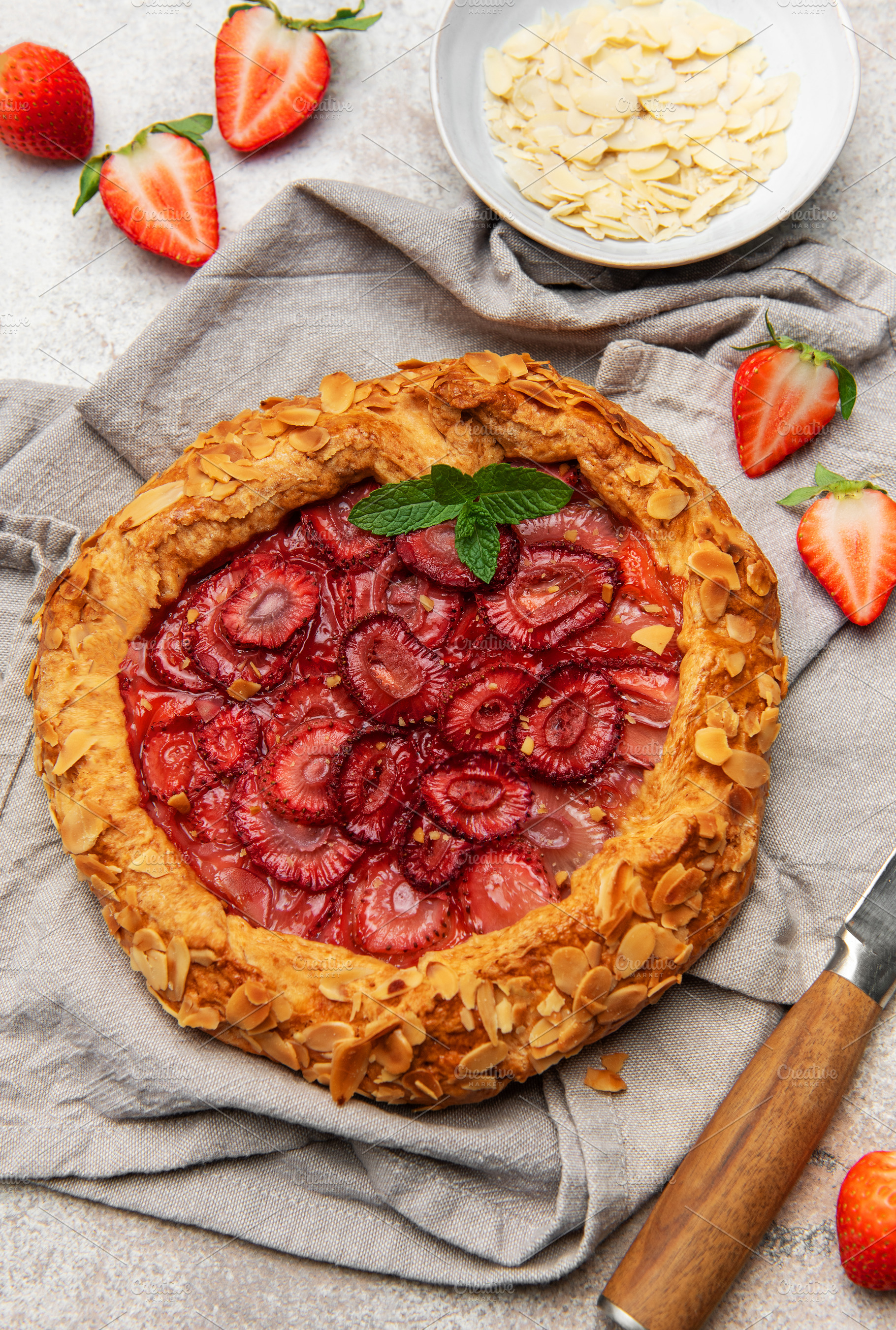 Delicious homemade strawberry galette with almond petals and fre, a Food & Drink Photo by Olena Rudo