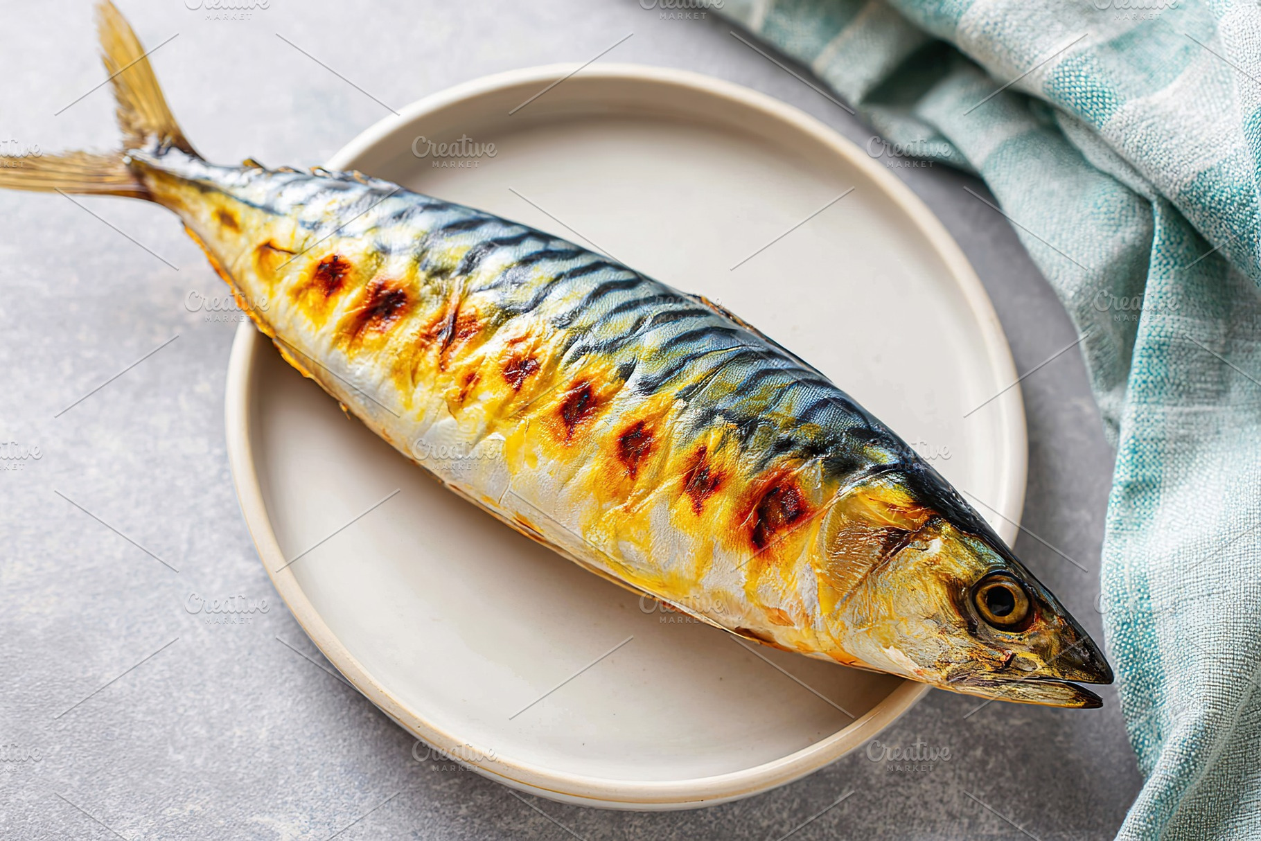 Grilled mackerel on a plate, a Food & Drink Photo by AlyaAnd