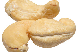 Heap of peeled cashew nuts on isolated background, a Food & Drink Photo by ndanko