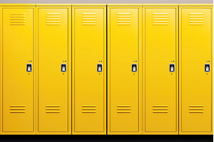 A row of closed yellow lockers with, a School & Education Photo by Sergey Kotenev