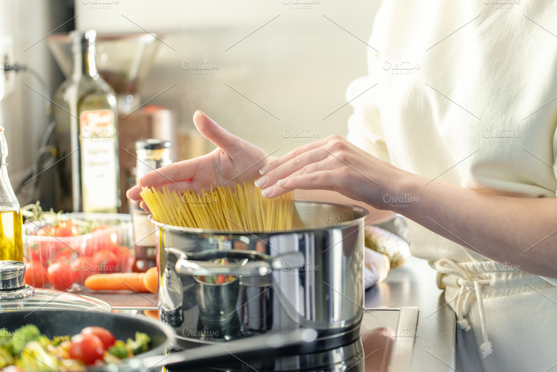 Girl cooking pasta spaghetti in pot, a Food & Drink Photo by Valeria Art