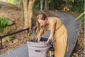 Mother changing her baby diaper in a, a Transportation Photo by Elizaveta Galitskaya