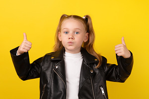 Young girl in a black leather jacket making a surprised face and, a Person Photo by Ales Munt