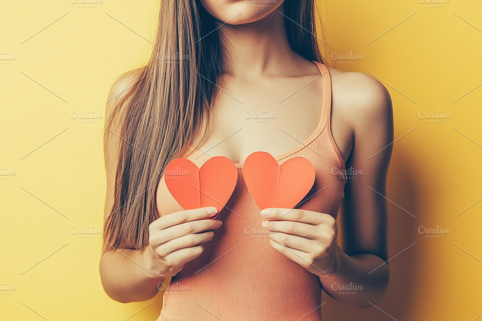 Happy young woman holds in hands paper heart, a Person Photo by AlyaAnd